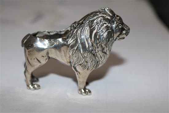An Edwardian silver pincushion in the form of a standing lion (cushion and tail deficient),
